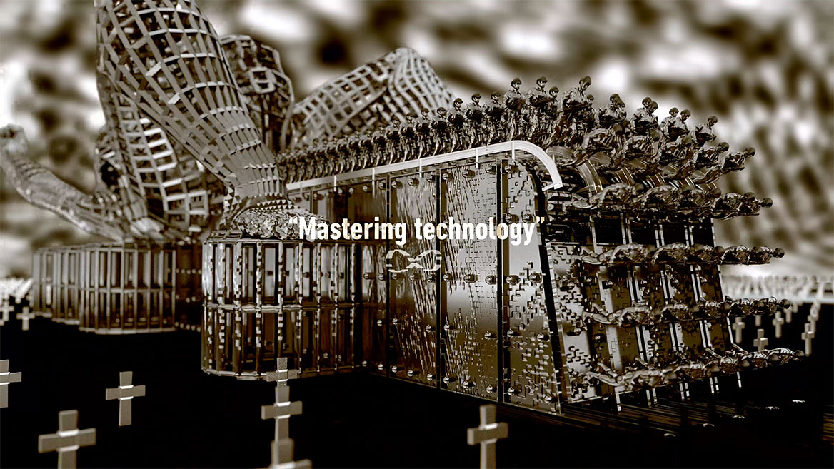 Standbild aus der Animation. Totale (über Eck) auf die Maschinerie. Die englischen Wörter -Mastering technology- stehen in weißer Typografie zentral im Bild und sind mit An- und Abführungszeichen gesetzt. Darunter ist das mathematische Unendlichkeitszeichen abgebildet, dass in der Animation fast durchweg um eine unsichtbare, vertikale Achse rotiert.