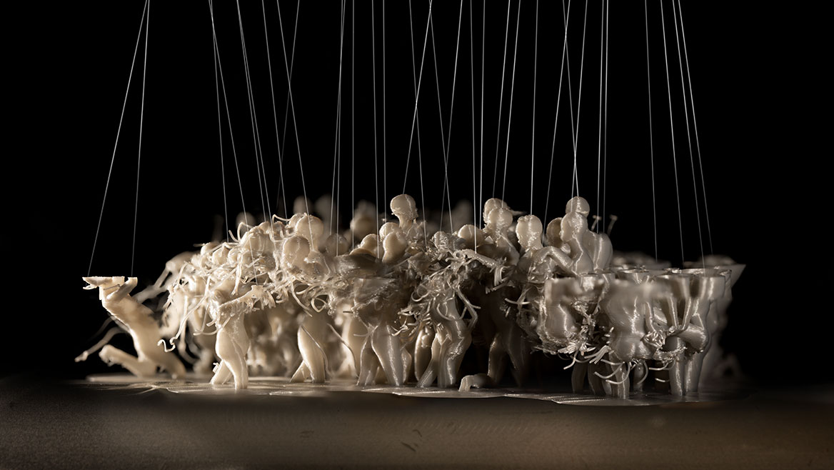 A group of figures hangs from threads that reach into the black sky. The figures are partially destroyed, with growths protruding from their body parts deforming them. The depth of field is reduced.